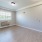 a room with a wood floor and a window