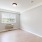 a room with a wood floor and a window