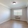 a room with a wood floor and a window